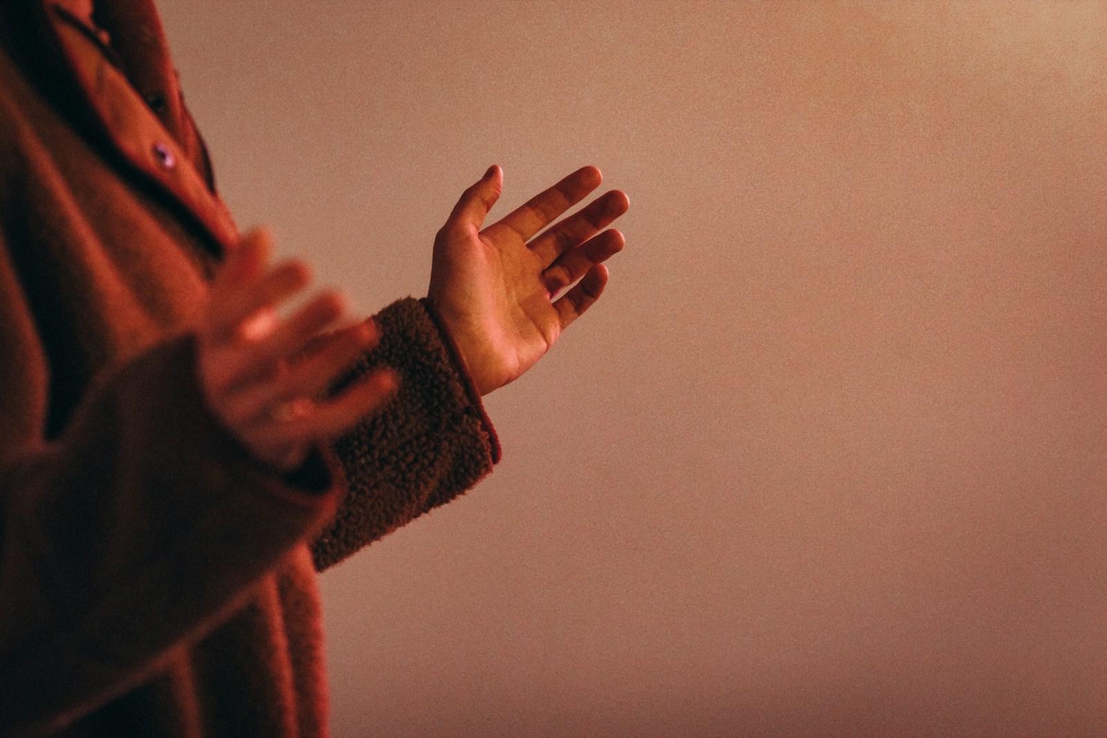 person in red sweater wearing silver ring